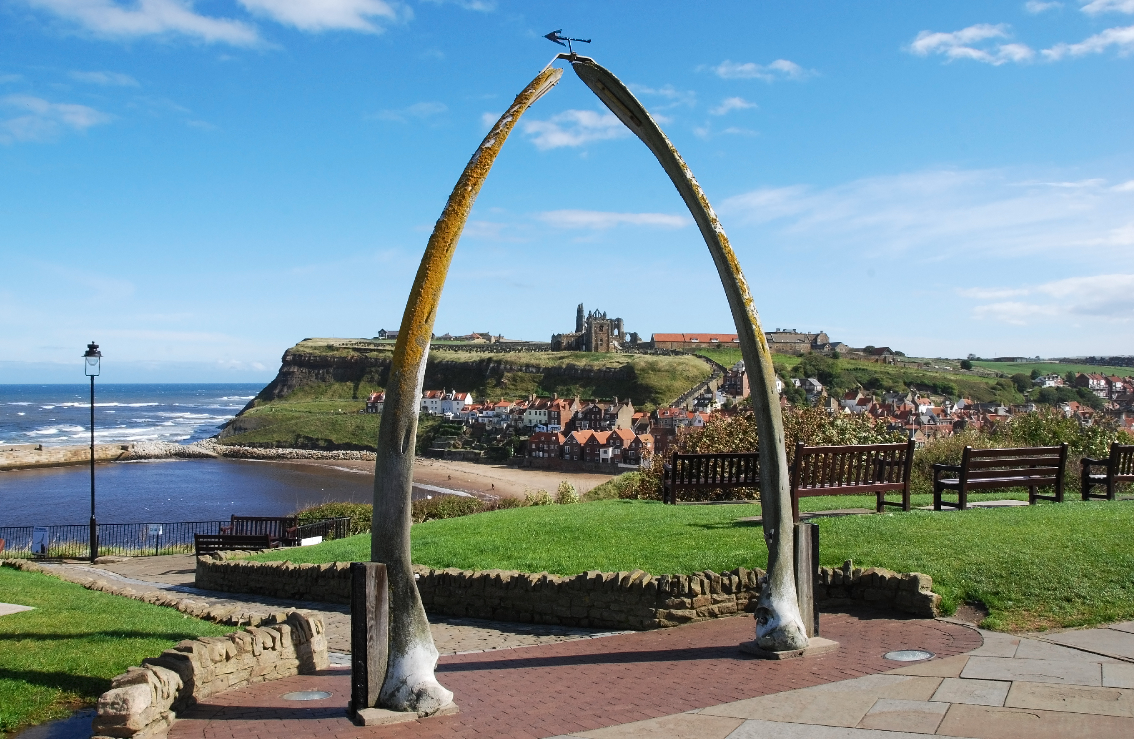 Whitby Abbey viewed through the whale bone arch overlooking the harbour in Whitby, North Yorkshire